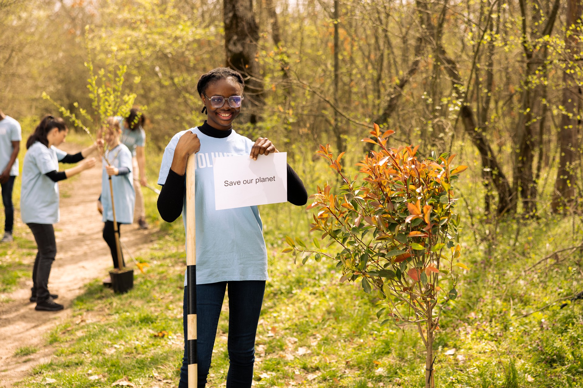 Portrait of african american girl holding banner with save our planet message